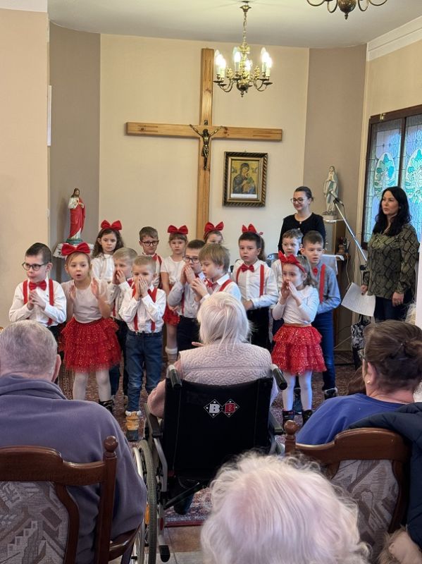 Przedszkolaki tańczą w rytm muzyki w kaplicy 